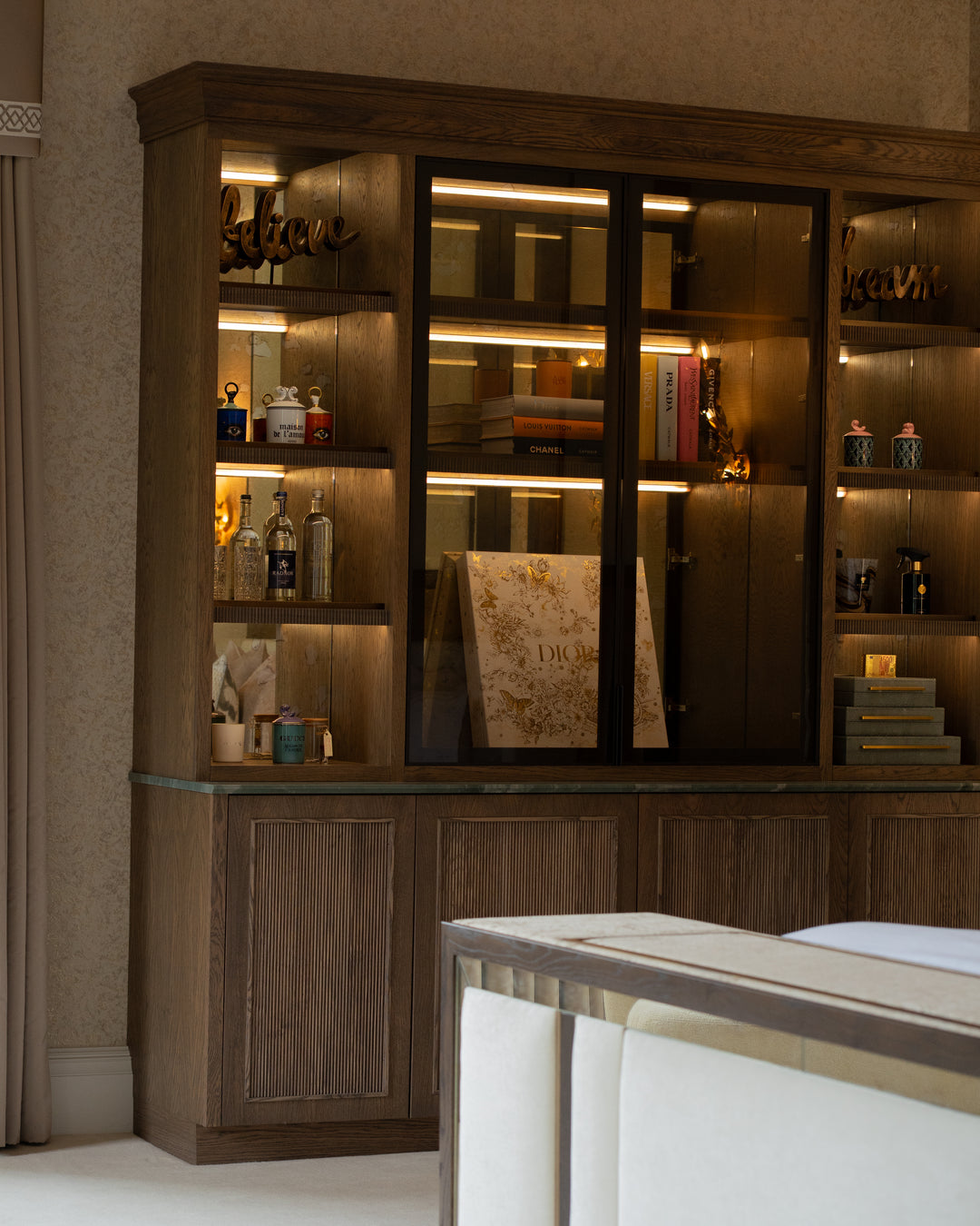 Wooden bar cabinet with shelves and a mirror in a room setting.
