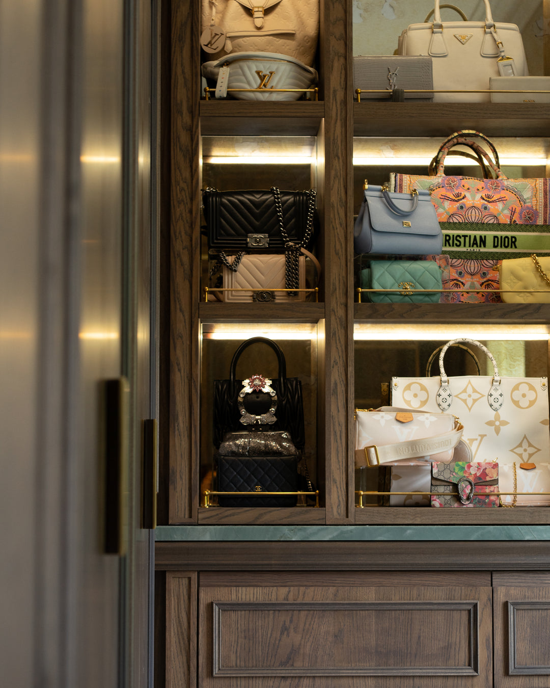 Display case with various designer handbags inside