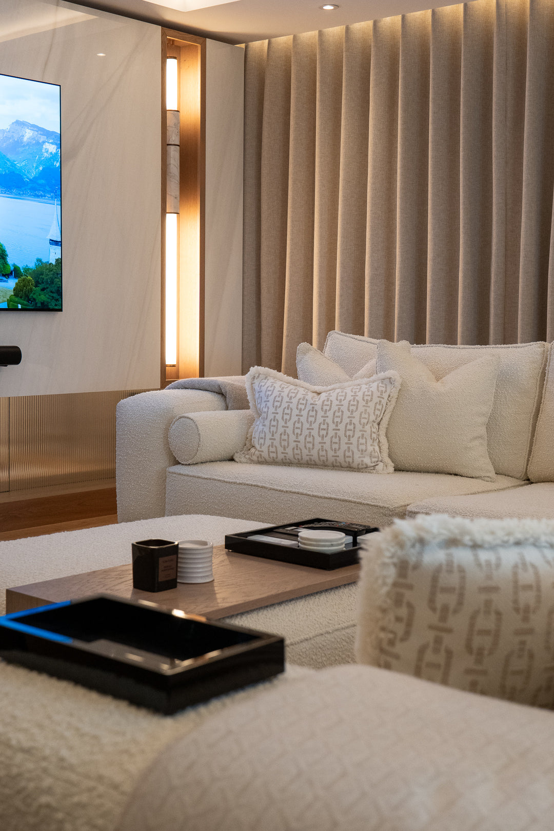 Modern living room with beige sofa, coffee table, and TV in a stylish interior.