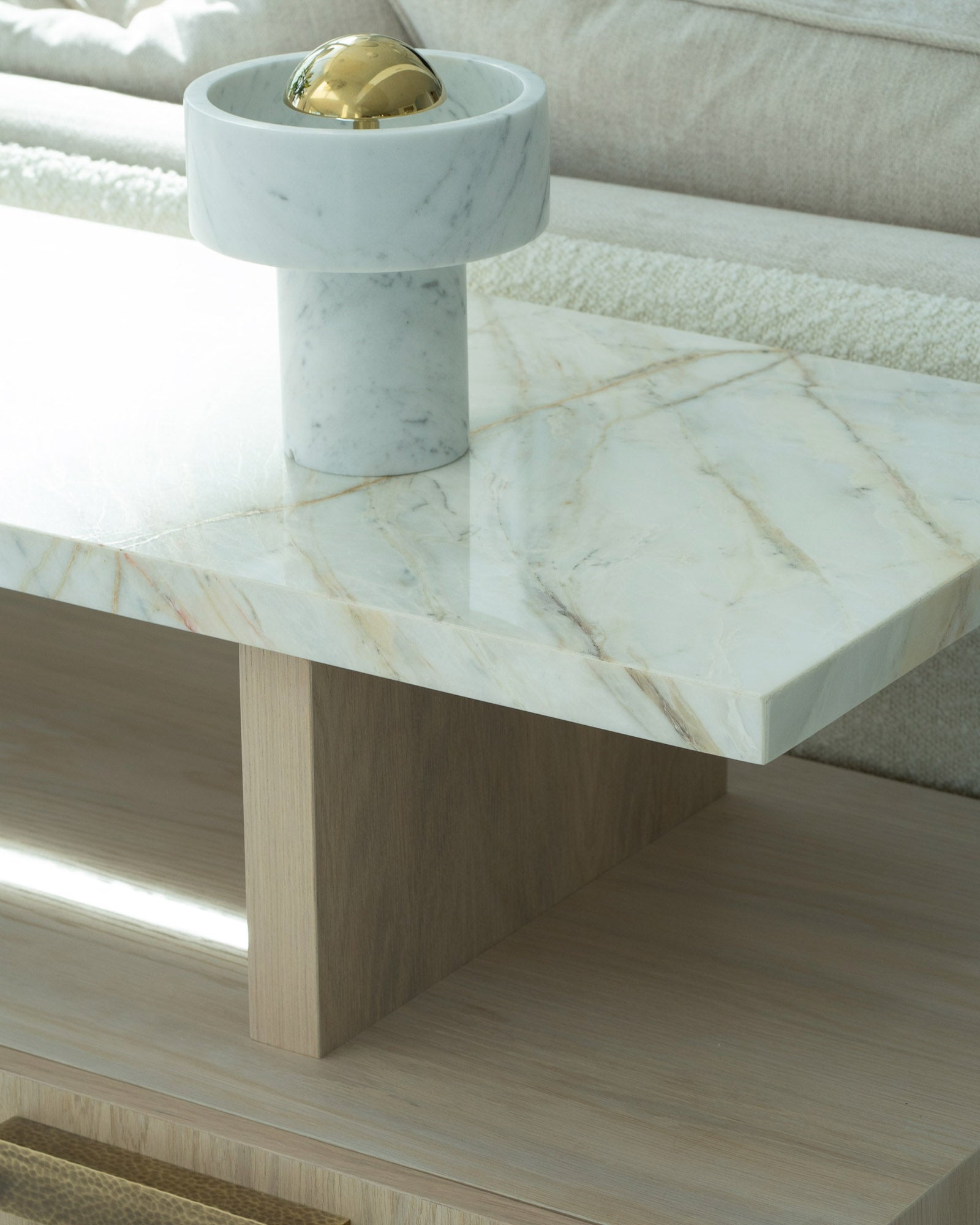 Detail of marble coffee table with decorative object in a luxury living room.