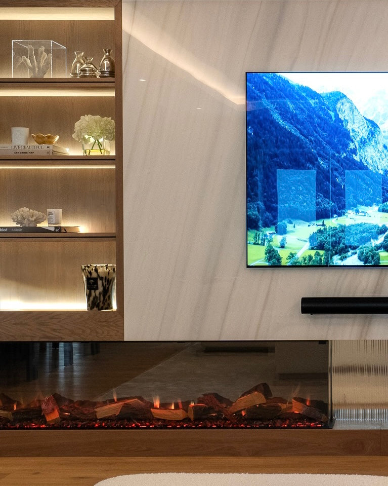 Modern living room with a television displaying a scenic landscape, a fireplace, and a wooden shelf.