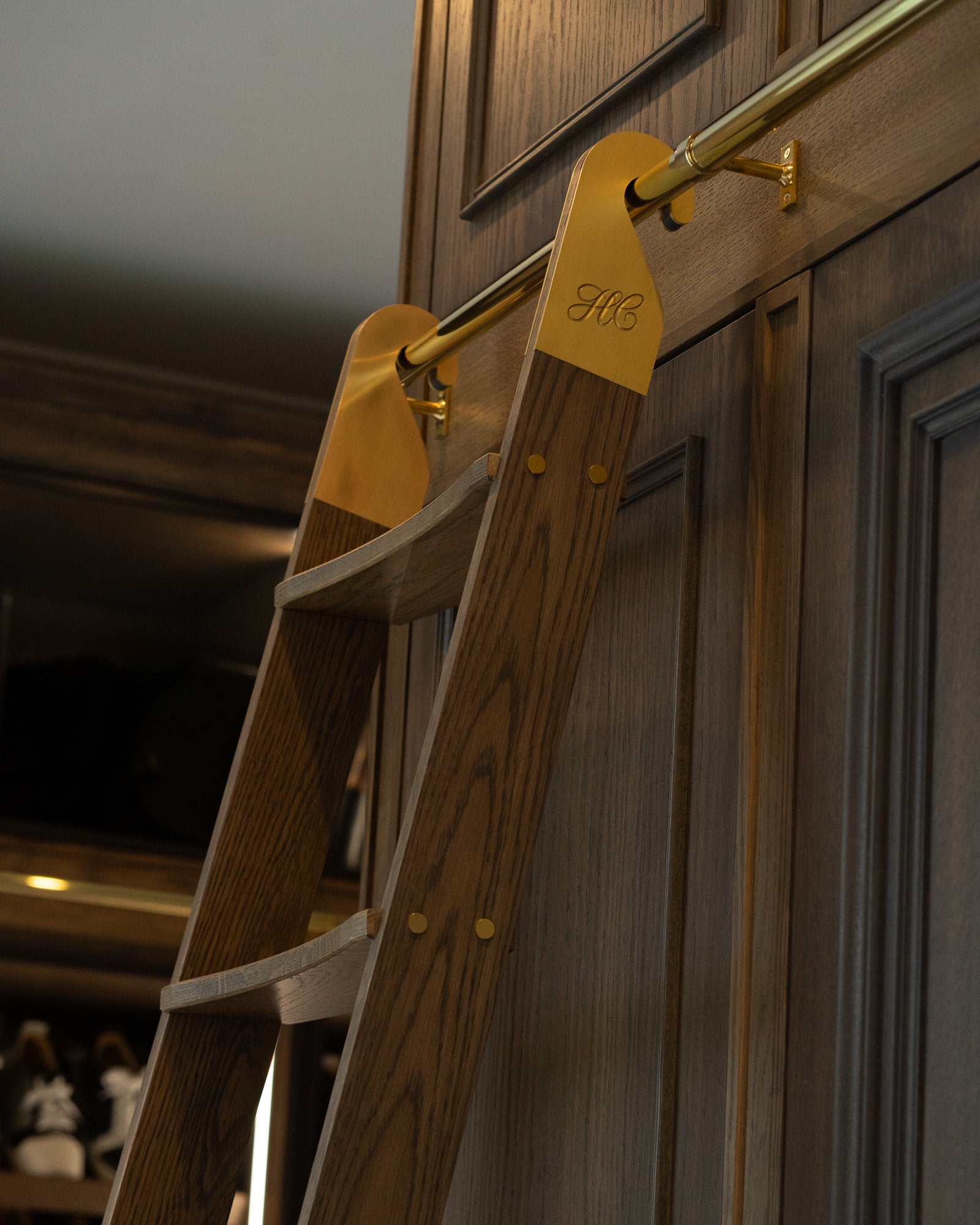 Bespoke walnut dressing room ladder with aged brass detailing at The Nottingham Residence