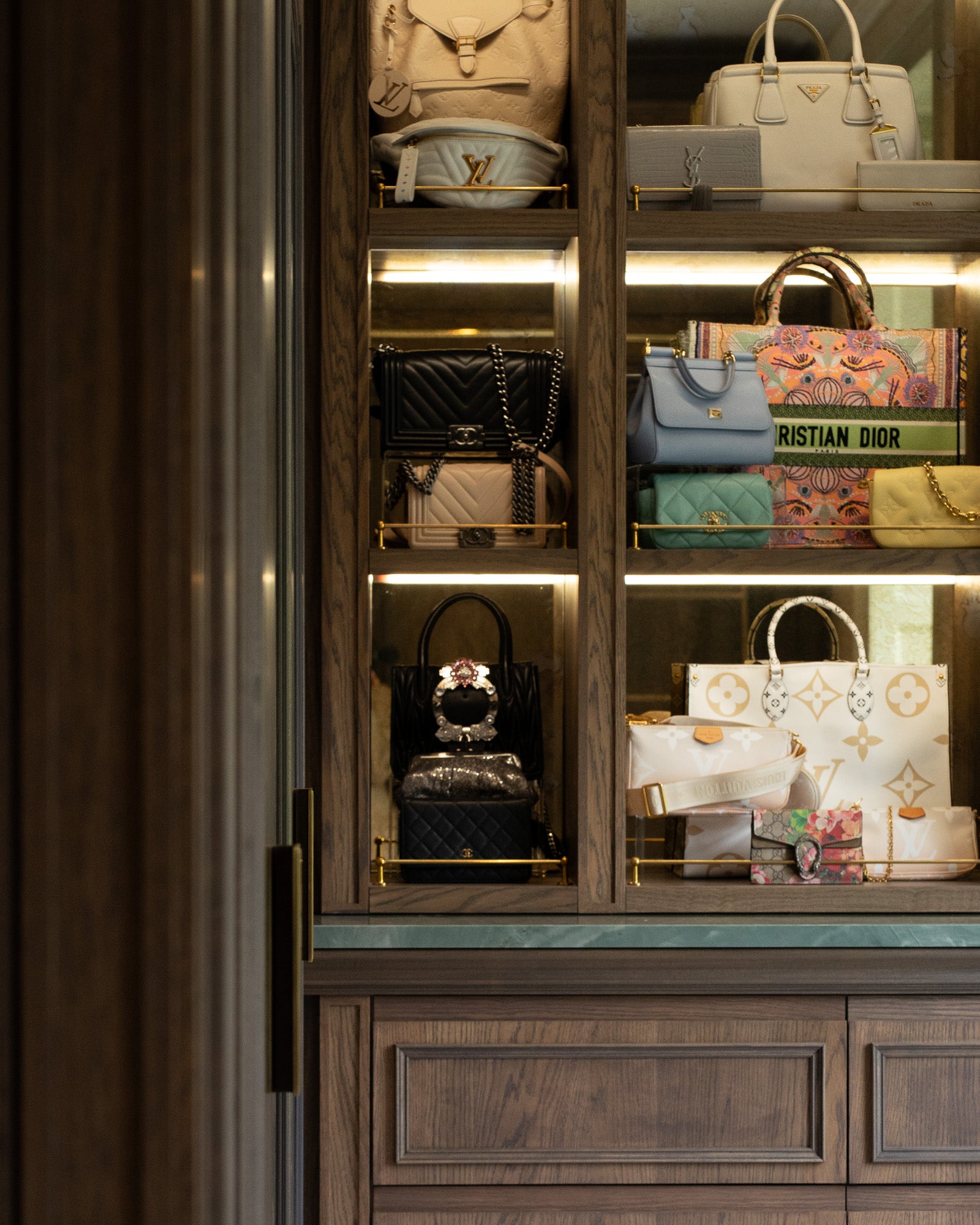 Illuminated bespoke handbag display within a luxury dressing room at The Nottingham Residence