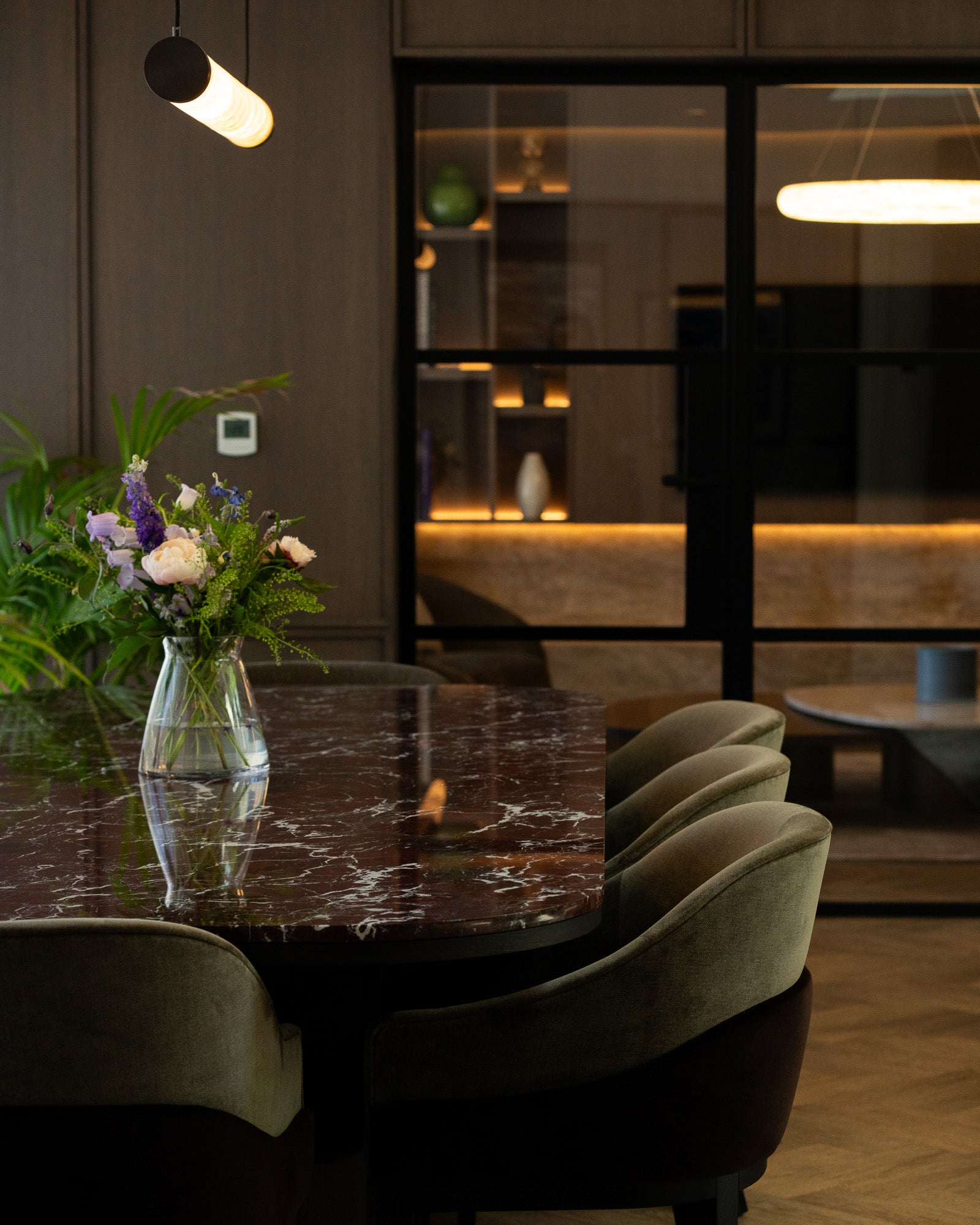 Luxury dining space with Rosso Levanto marble table and bespoke upholstered seating