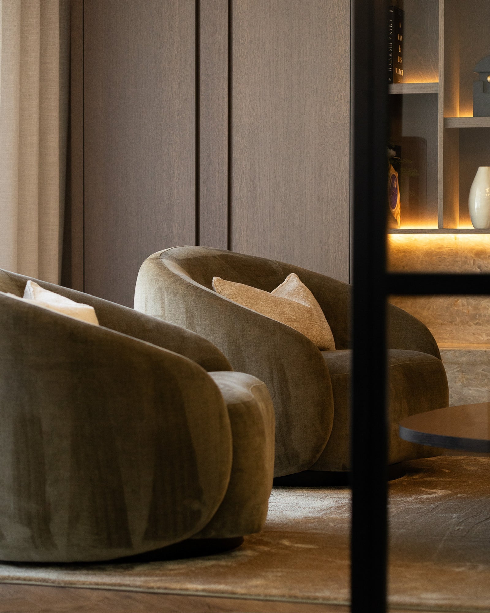 Curved lounge chairs within a luxury living space at The Sevenoaks Residence