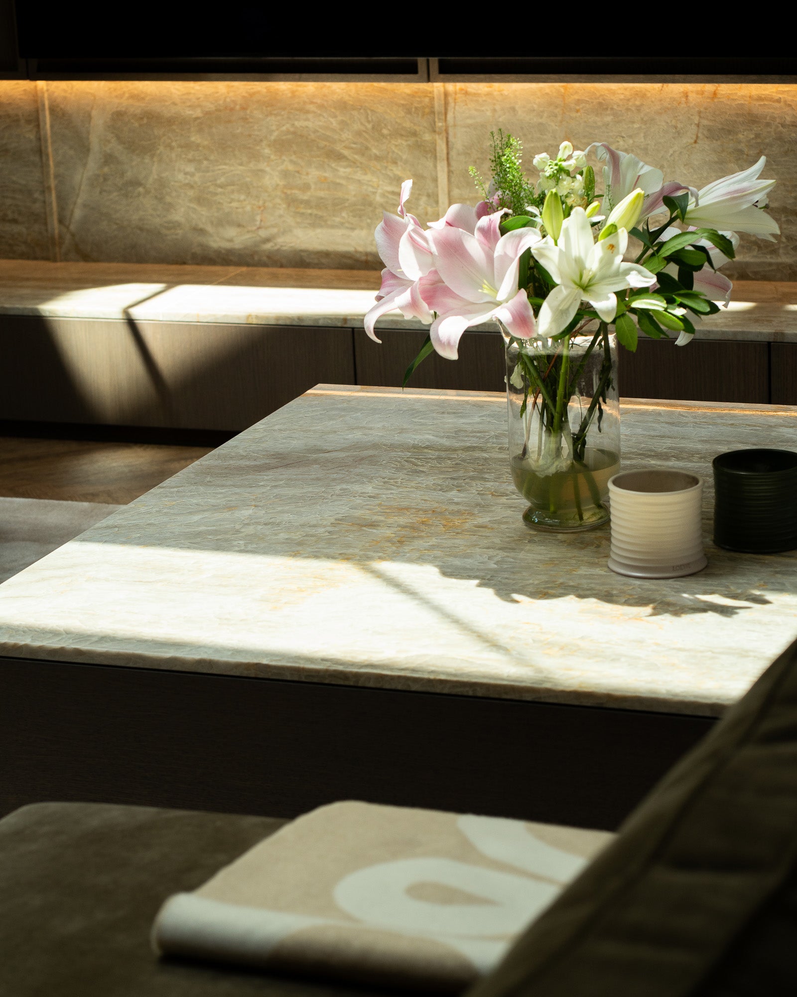 Stone coffee table styled with fresh flowers within a luxury living space